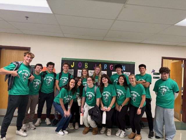 A high school group wearing matching green custom printed t-shirts from Hatrick Sportswear